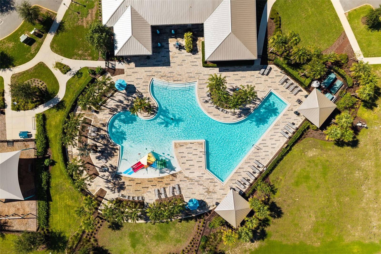 Aerial view of the Trinity Lakes resort-style community pool and surrounding amenity area. - 7104 DILLY LAKE AVE, GROVELAND