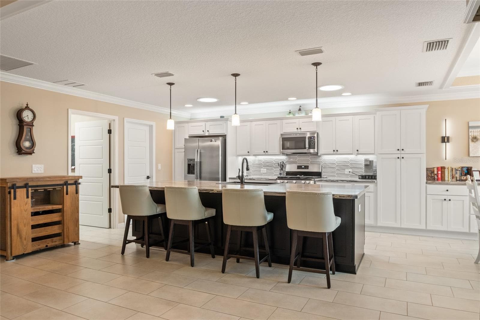 Beautiful backsplash and several pull out drawers in kitchen cabinets and pantry. - 4529 SAMANTHA CT, THE VILLAGES