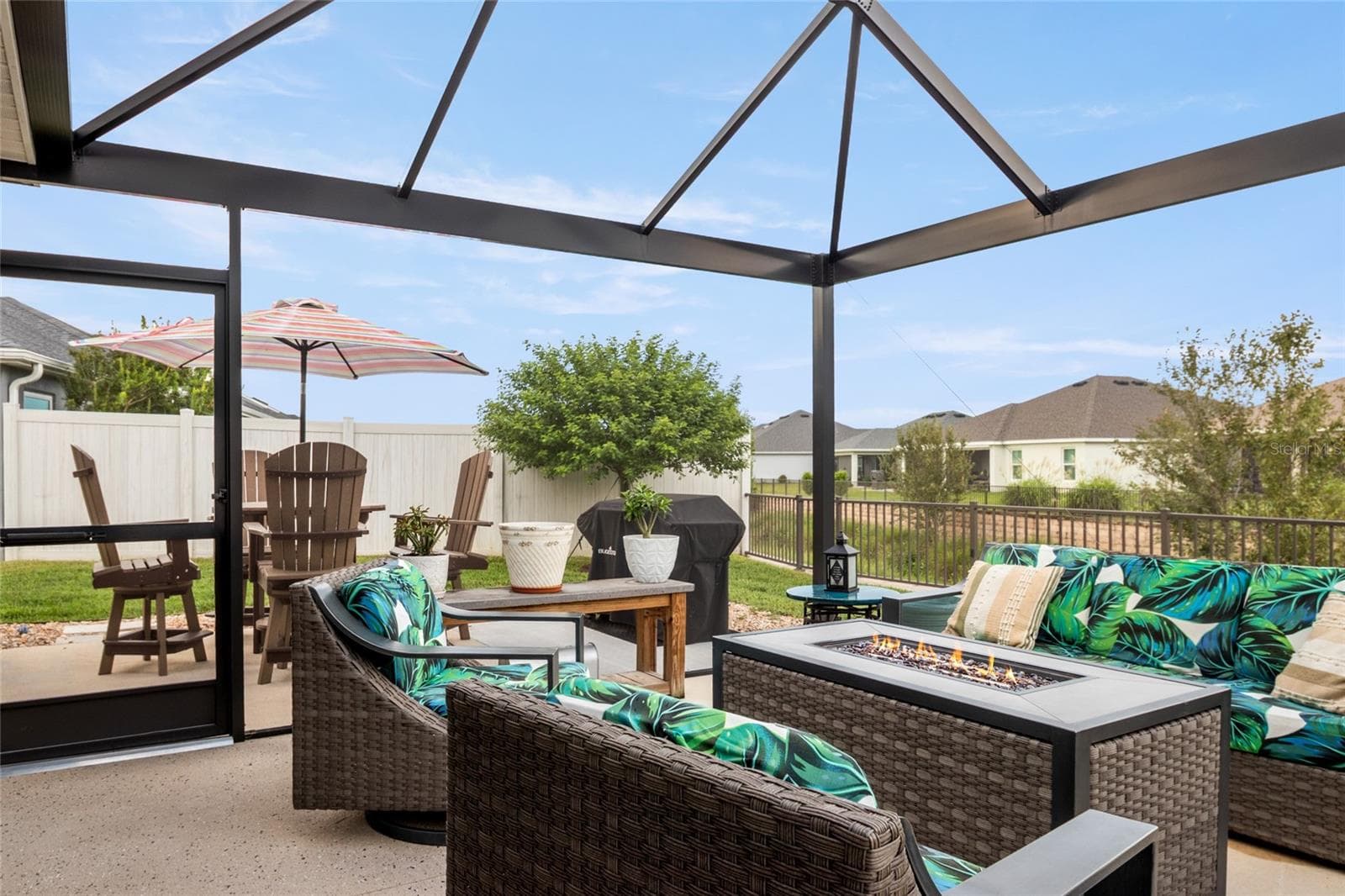 Enjoy time on the screened in lanai with your morning cup of coffee or happy hour with friends.  Enjoying the beauty that surrounds this property. - 4529 SAMANTHA CT, THE VILLAGES