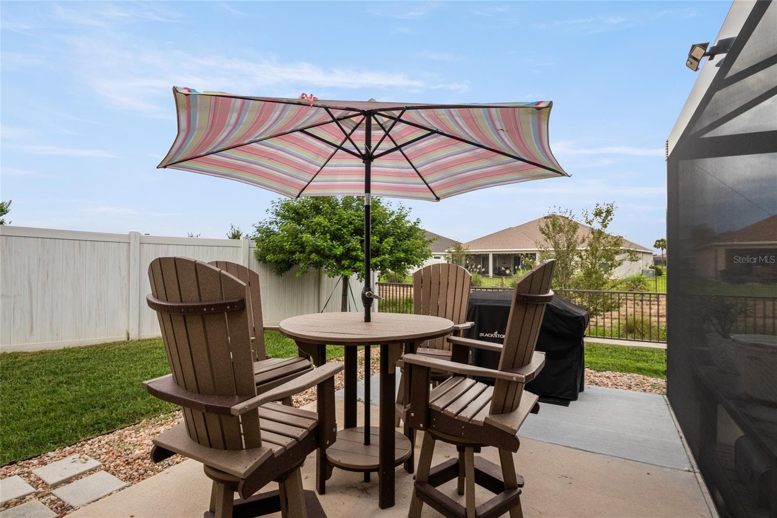 Patio area for dining and grilling.  Grassy area making this a perfect pet friendly space. - 4529 SAMANTHA CT, THE VILLAGES