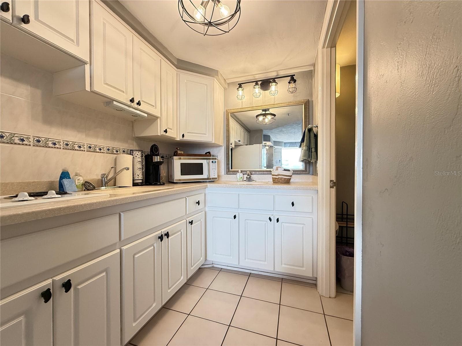 Kitchenette with stove top, microwave and a full size refrigerator. - 2700 N ATLANTIC AVE #509, DAYTONA BEACH