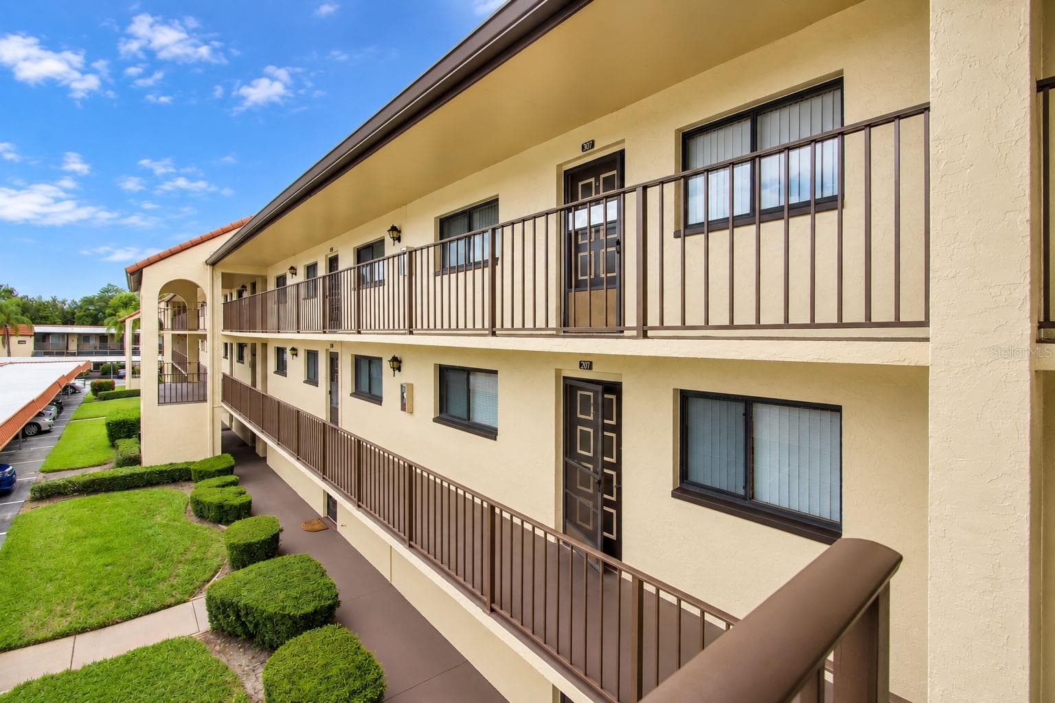 Exterior view of the condominium building. - 2440 WINDING CREEK BLVD #307, CLEARWATER