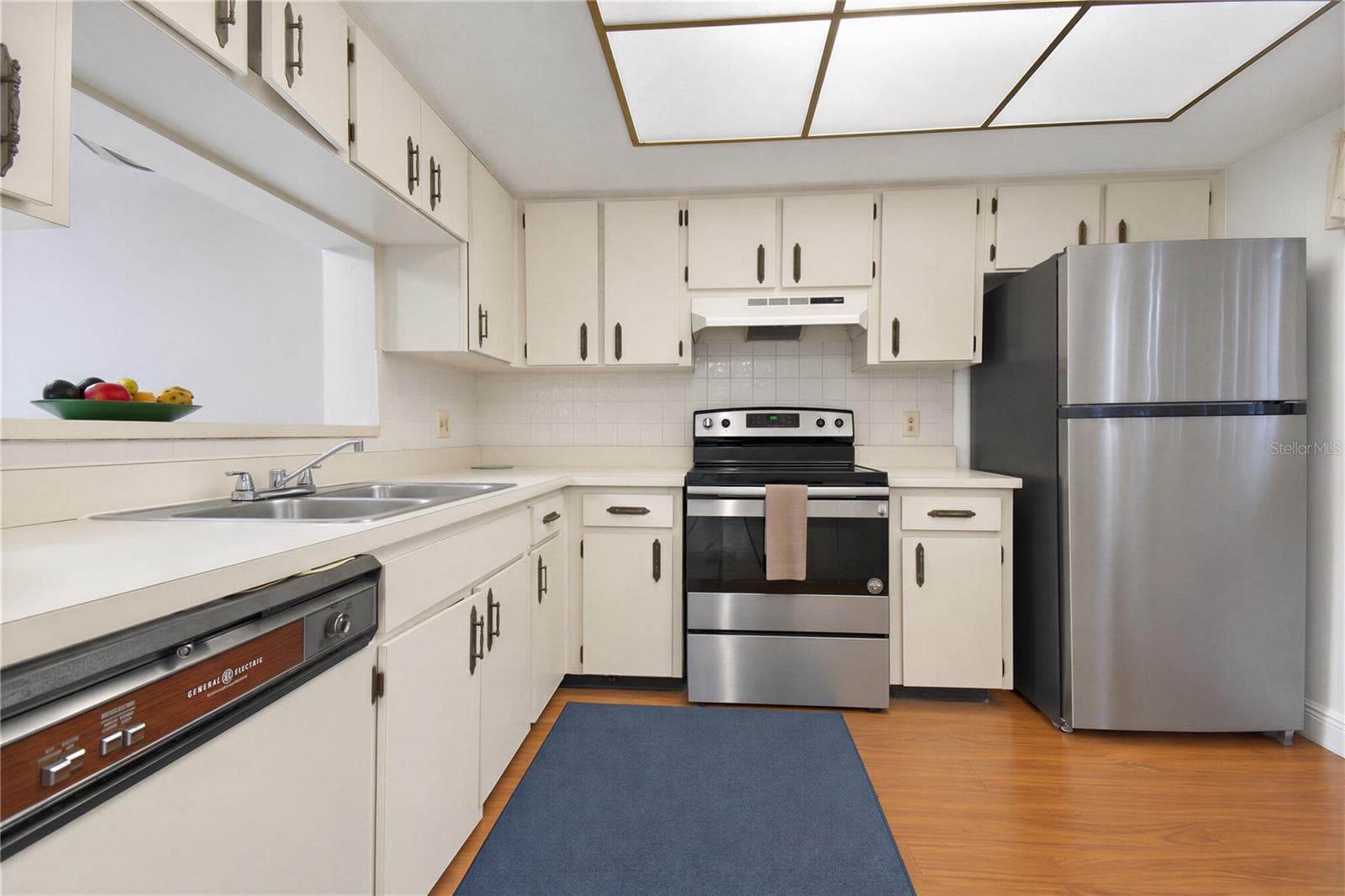 Bright kitchen with ample cabinetry and counter space. - 2440 WINDING CREEK BLVD #307, CLEARWATER