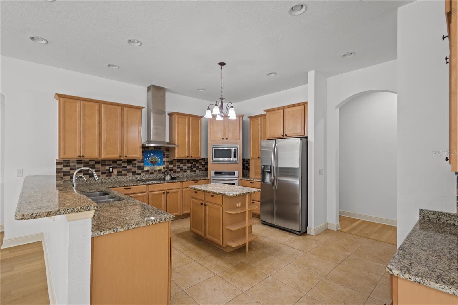 The spacious kitchen offers abundant cabinetry, generous workspace, and exceptional storage. - 14834 MAN O WAR DR, ODESSA
