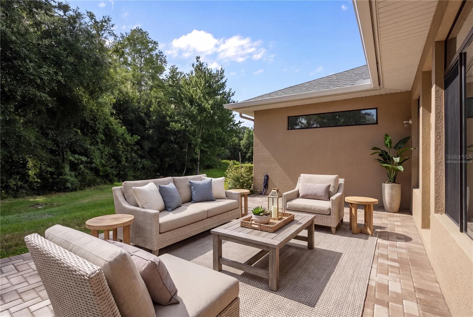 Extended pavered lanai in backyard provides great entertaining space and phenomenal views - virtually staged - 14834 MAN O WAR DR, ODESSA