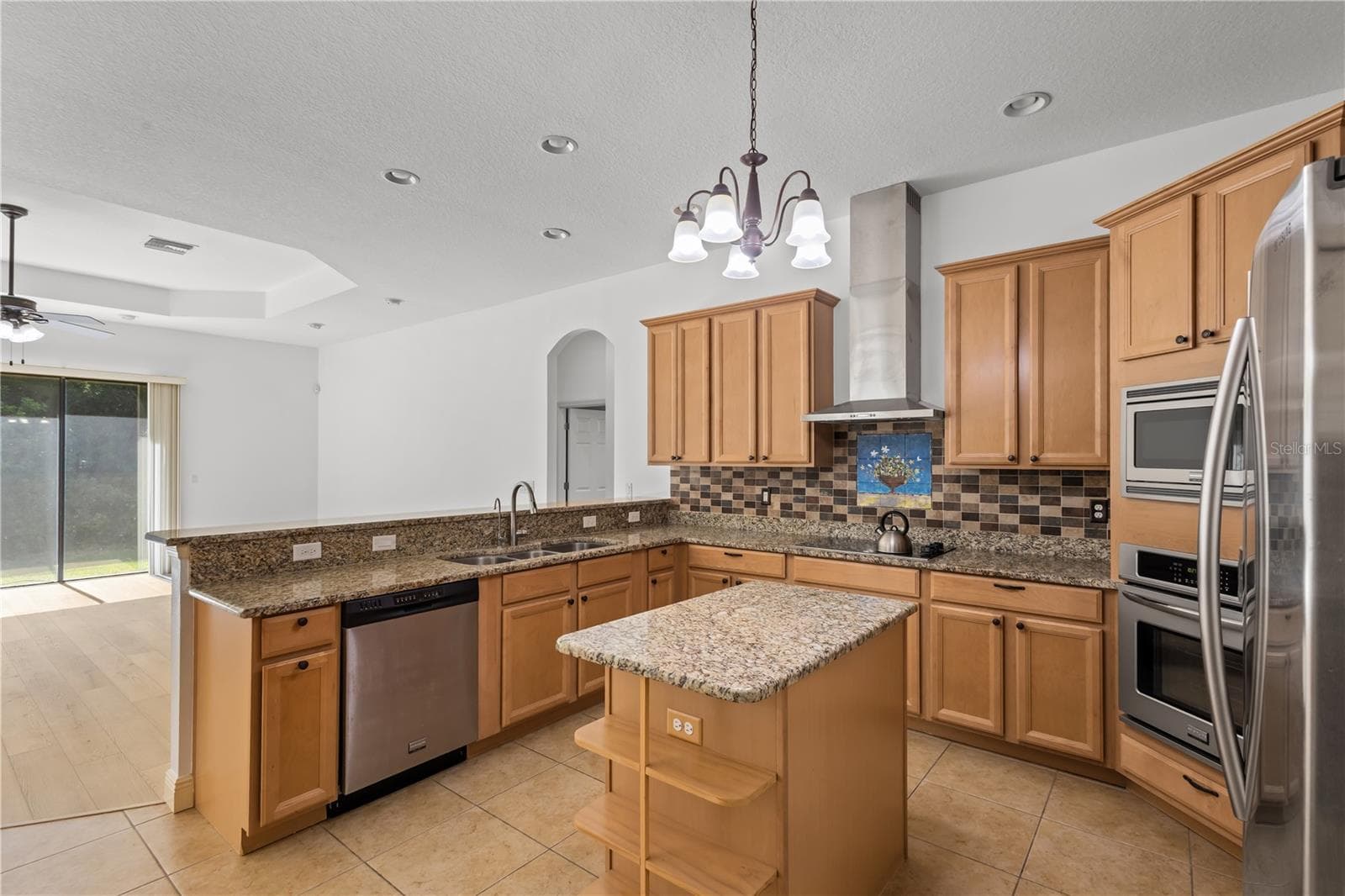 The spacious kitchen offers abundant cabinetry, generous workspace, and exceptional storage. - 14834 MAN O WAR DR, ODESSA