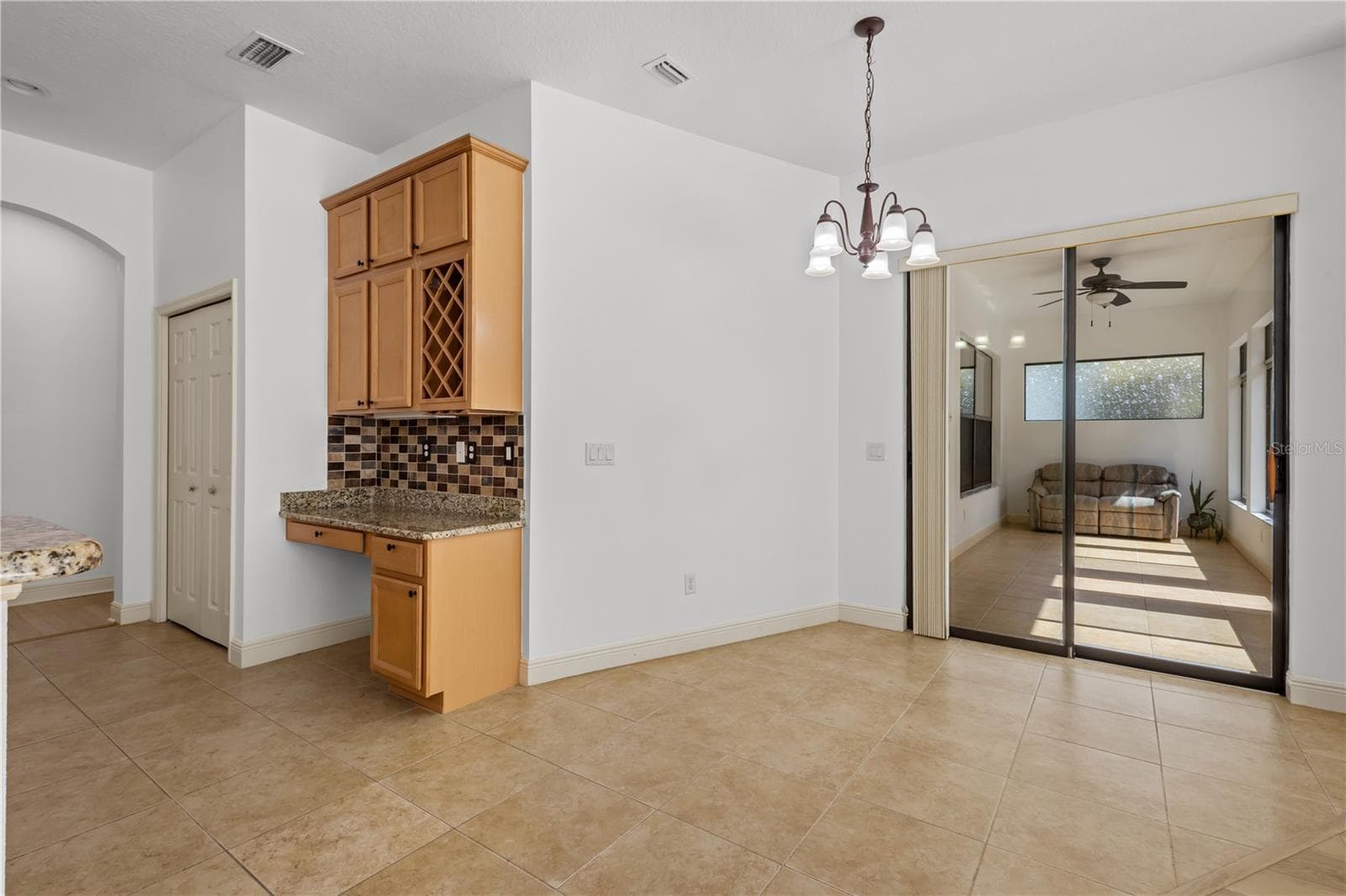 Room for eat in breakfast area off kitchen, with sliding door access to air conditioned Florida room. - 14834 MAN O WAR DR, ODESSA