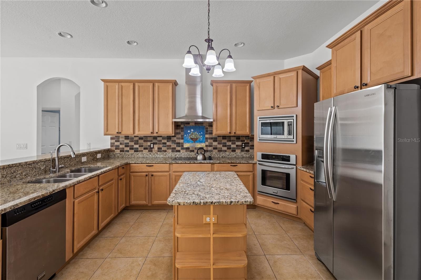 The spacious kitchen offers abundant cabinetry, generous workspace, and exceptional storage. - 14834 MAN O WAR DR, ODESSA