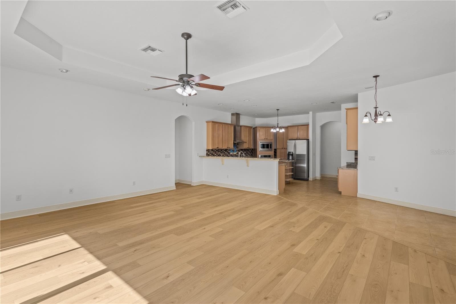 The open connection to the kitchen makes this space ideal for entertaining and spending time together. - 14834 MAN O WAR DR, ODESSA