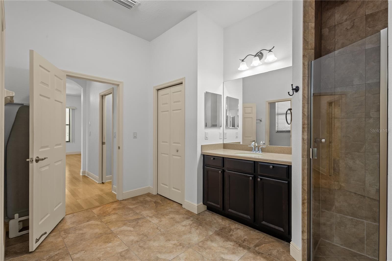 En suite primary bathroom with double sinks, walk in shower, and garden tub - 14834 MAN O WAR DR, ODESSA