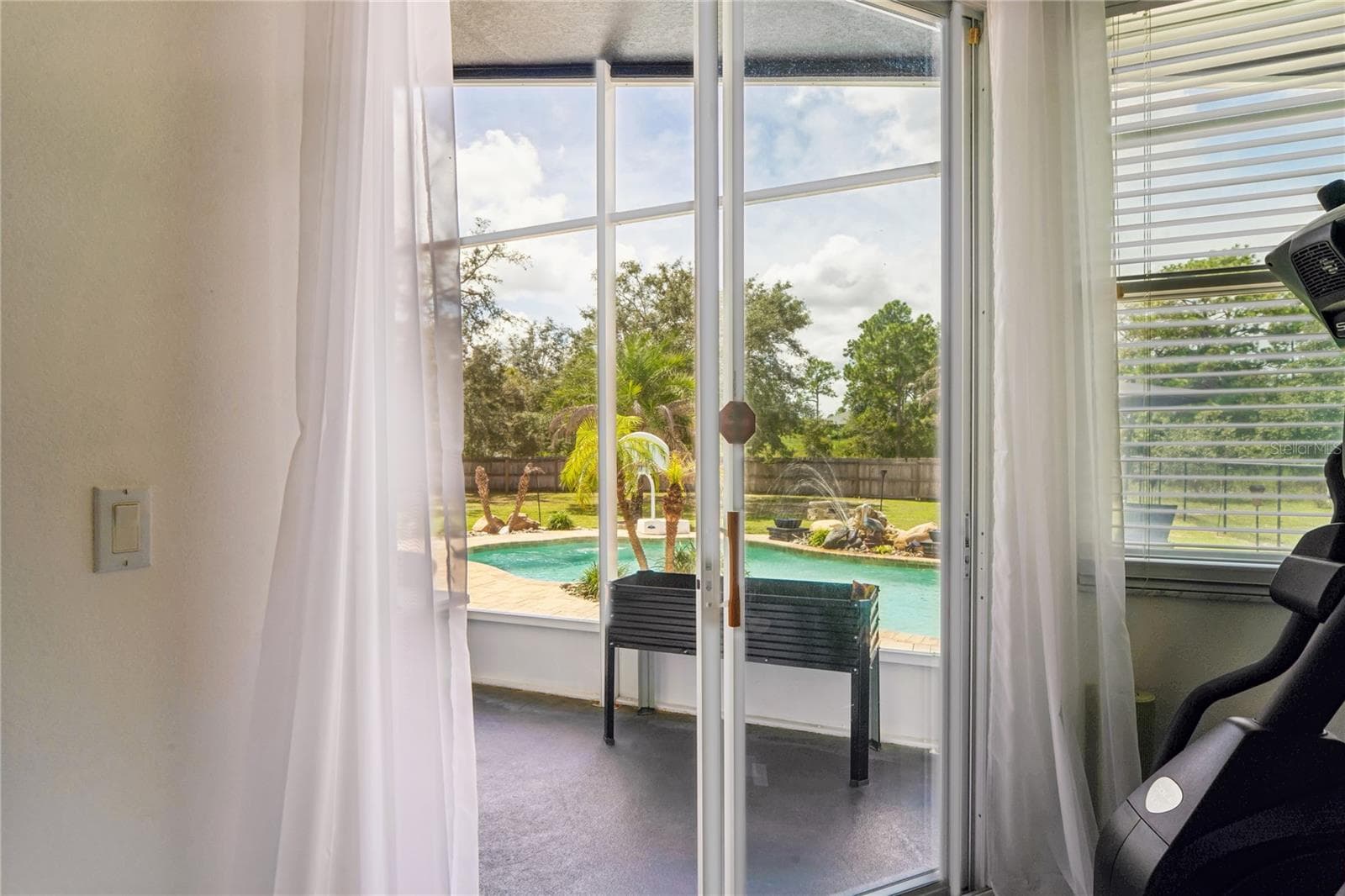 Primary suite looking onto pool - 11309 LAPWING RD, WEEKI WACHEE