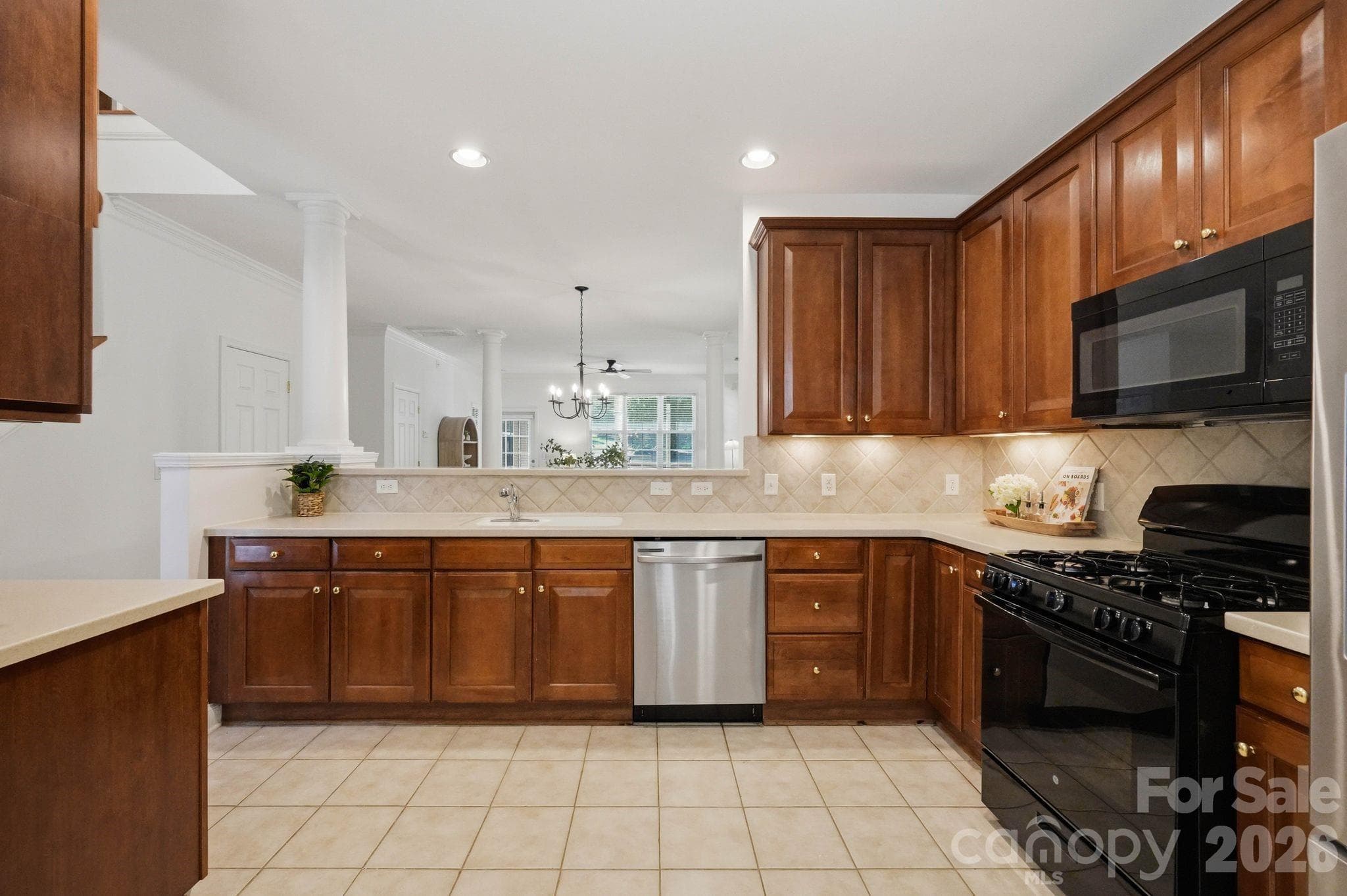 Open kitchen flows seamlessly into the dining and living areas. - 18810 Cloverstone Circle, Cornelius