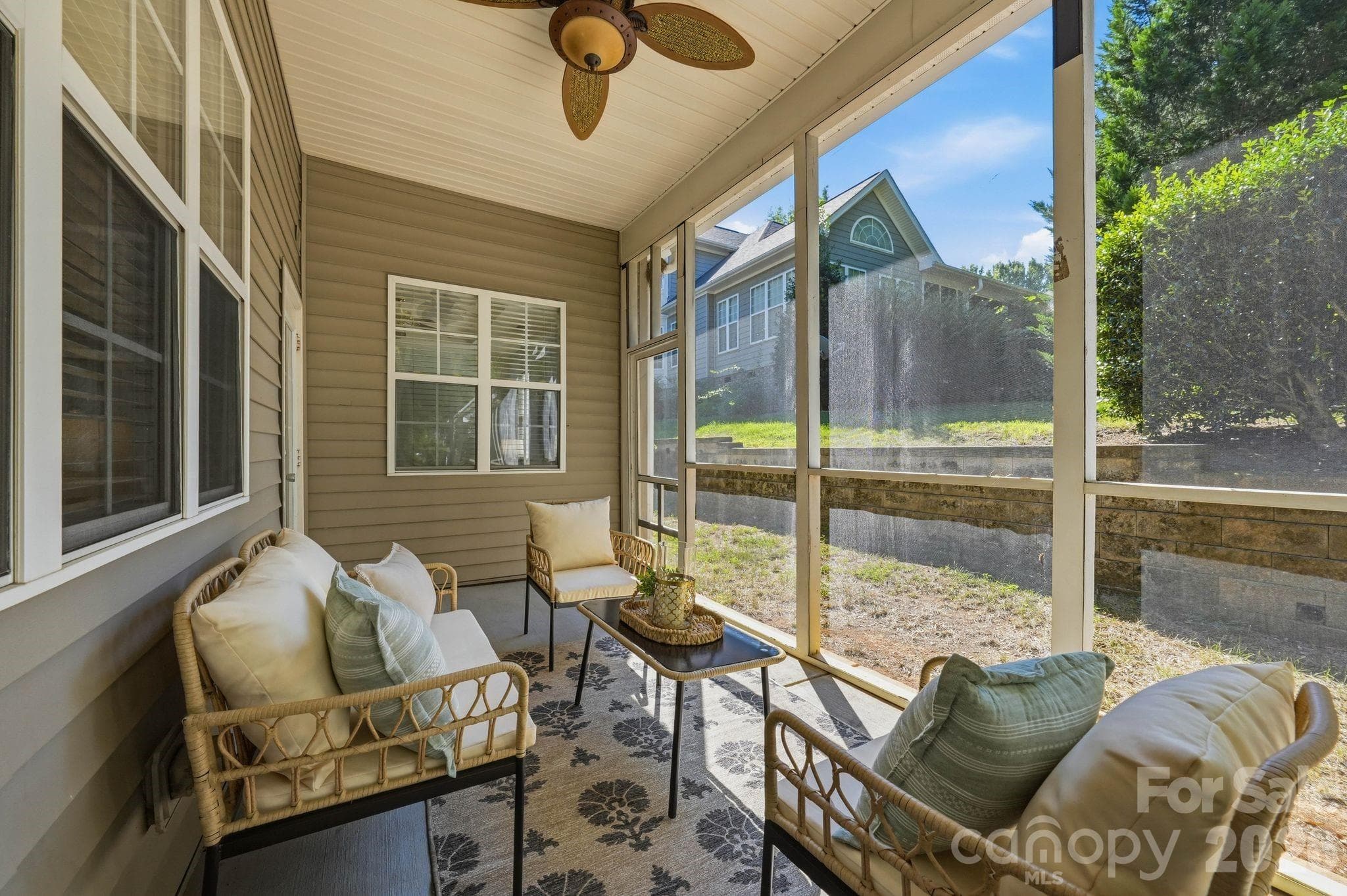 Easy indoor-outdoor flow from the family room to the screened rear porch. - 18810 Cloverstone Circle, Cornelius