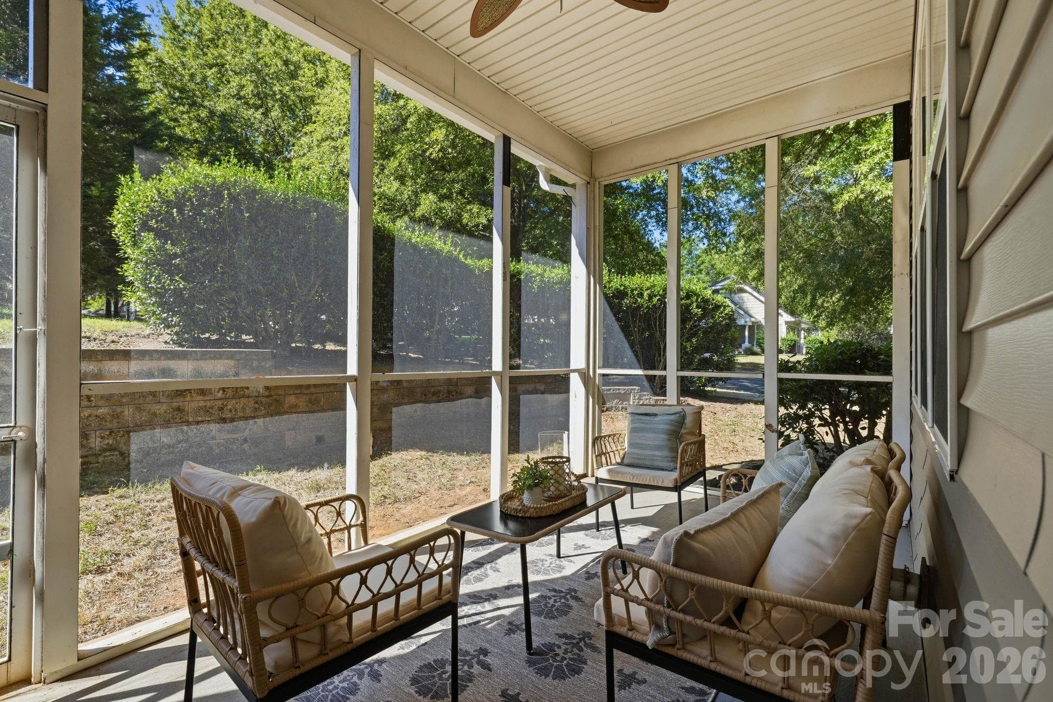 Covered screened porch offers a comfortable place to enjoy the outdoors throughout much of the year. - 18810 Cloverstone Circle, Cornelius