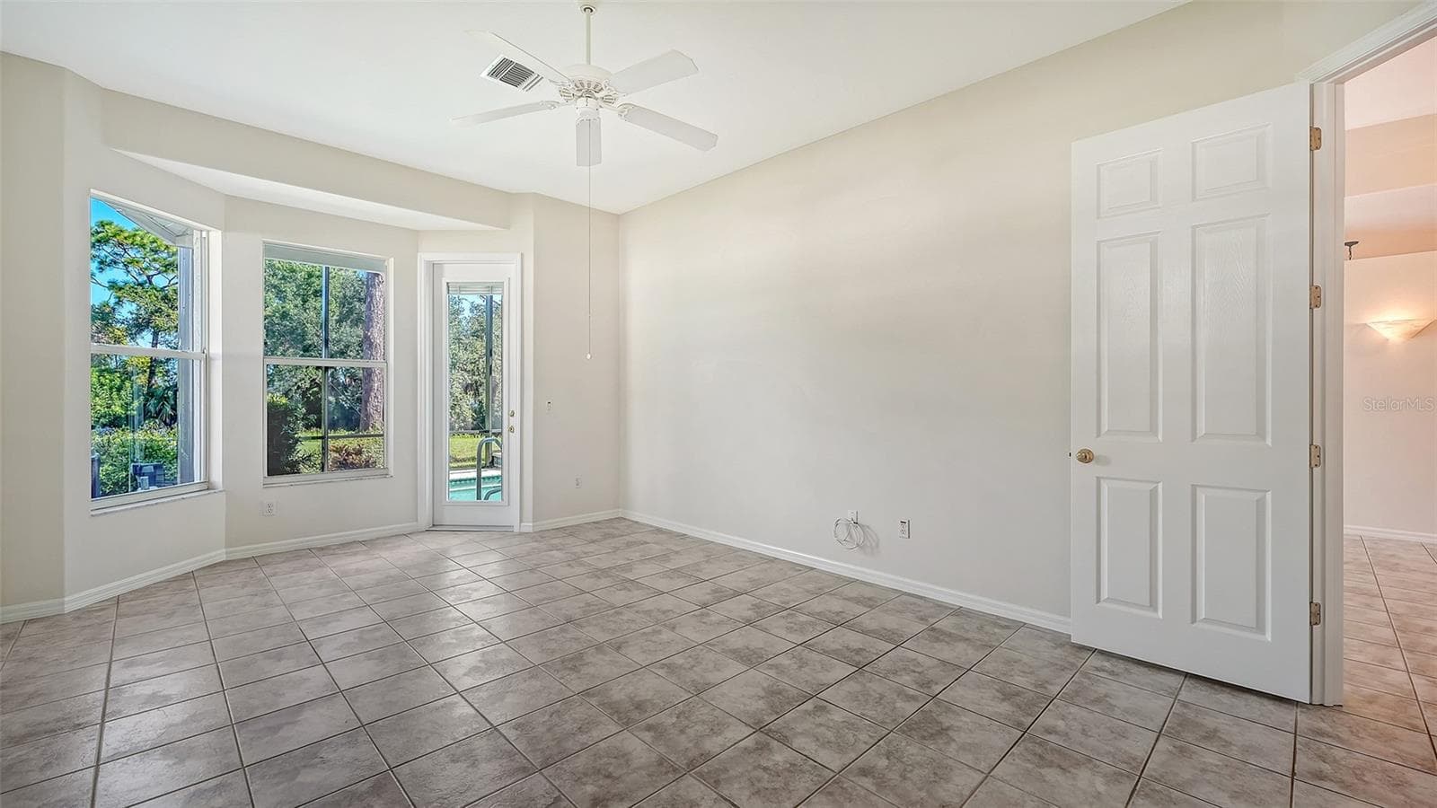 Primary bedroom with door to lanai - 342 MELROSE CT, VENICE