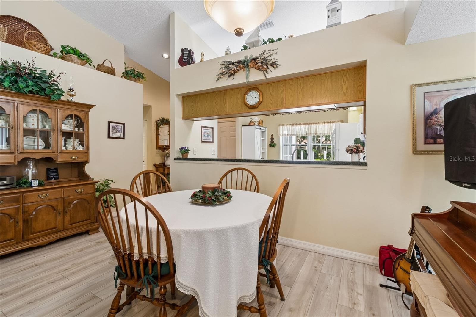 Dining room with view into kitchen - 5213 LOCHMEAD TER, ZEPHYRHILLS