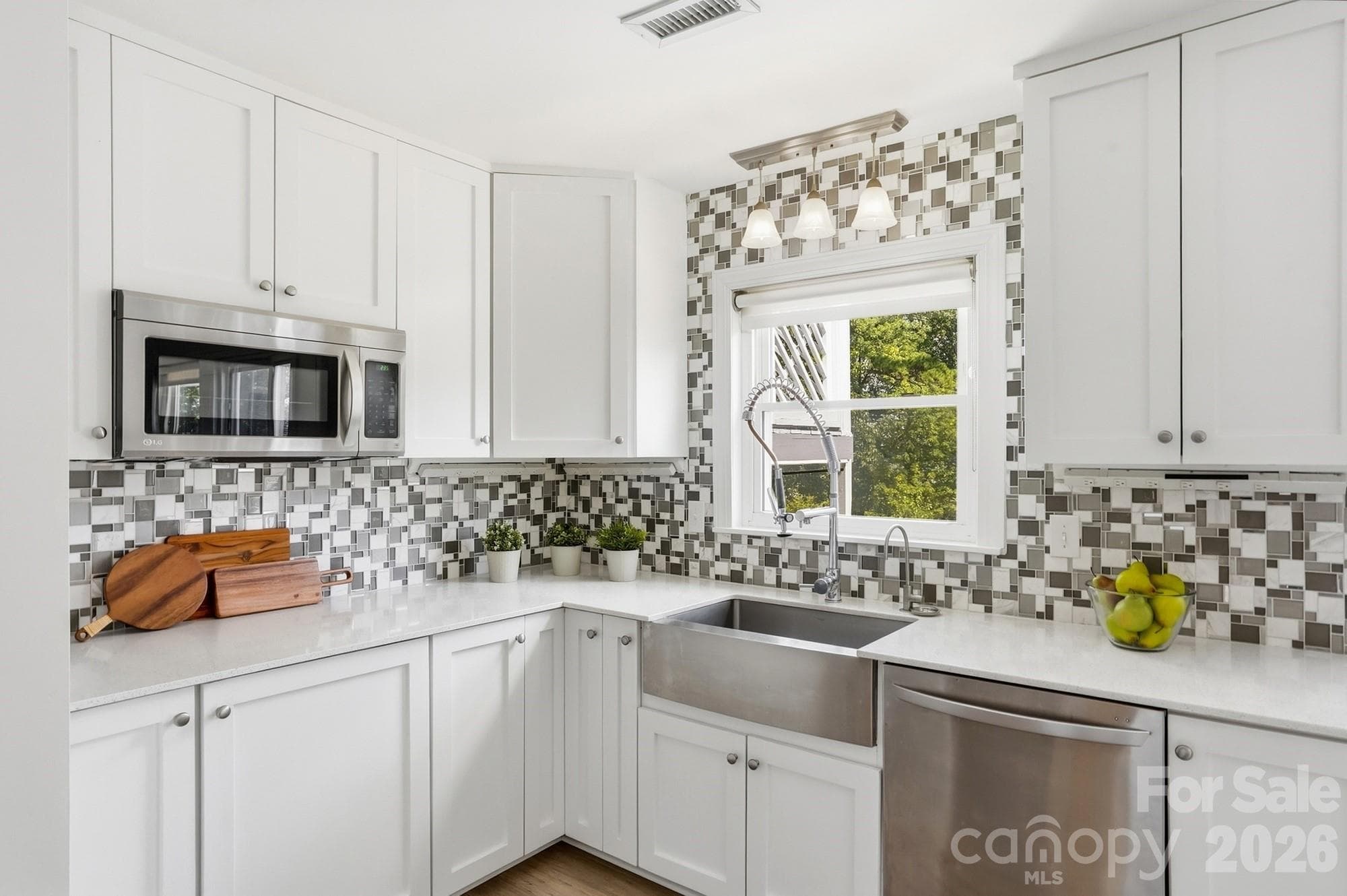 Apron-front stainless sink overlooking the backyard—because even doing the dishes is better with a great view! - 3022 Point Clear Drive, Tega Cay