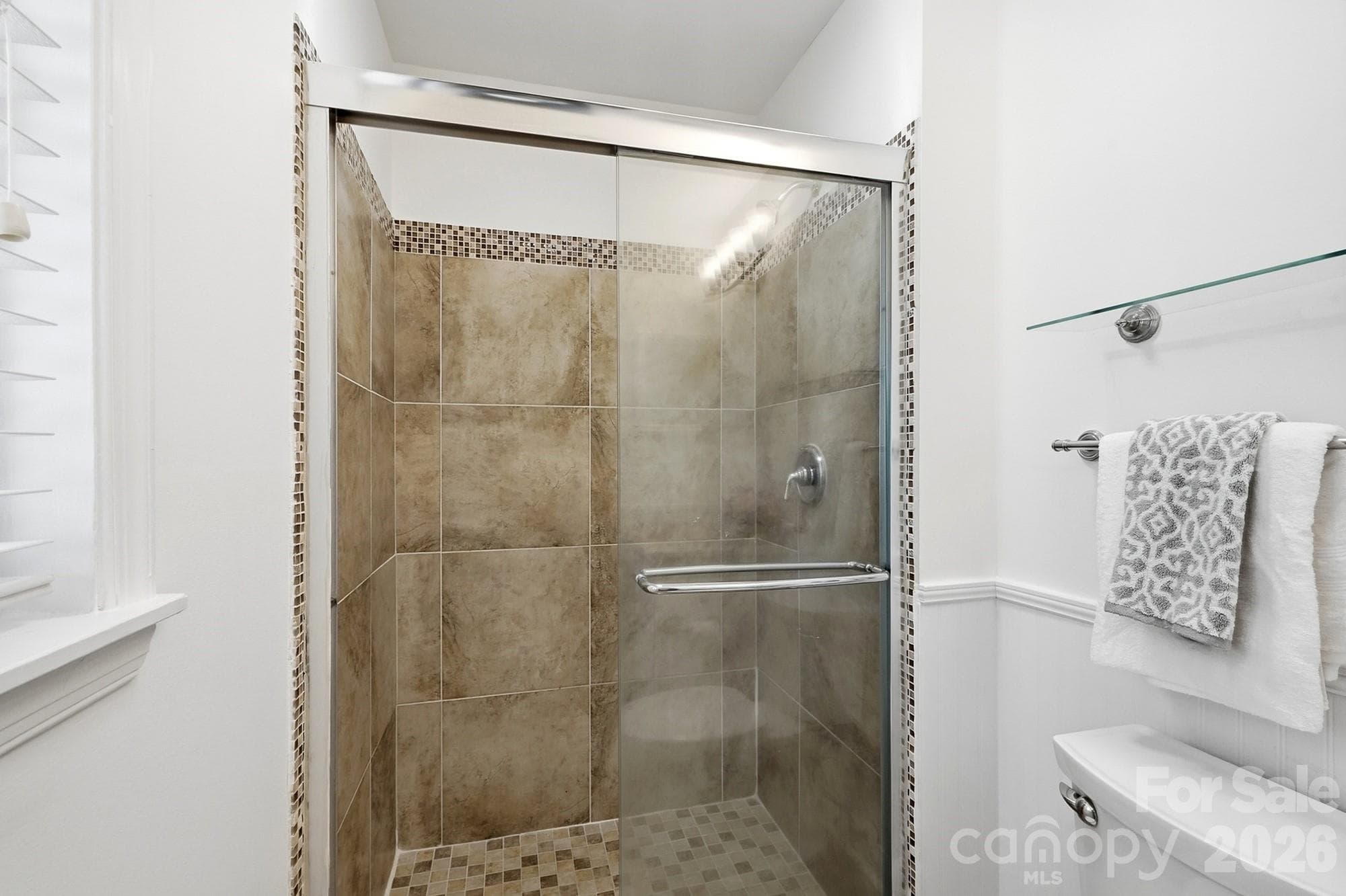 Inviting primary bathroom with a fully tiled walk-in shower. - 3022 Point Clear Drive, Tega Cay