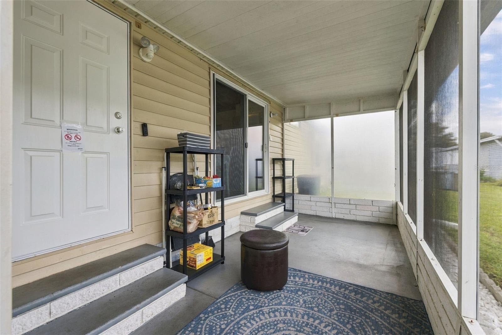 Screened in lanai entrance with sliding glass doors that also access the kitchen - 3041 SHORT LEAF ST, WESLEY CHAPEL