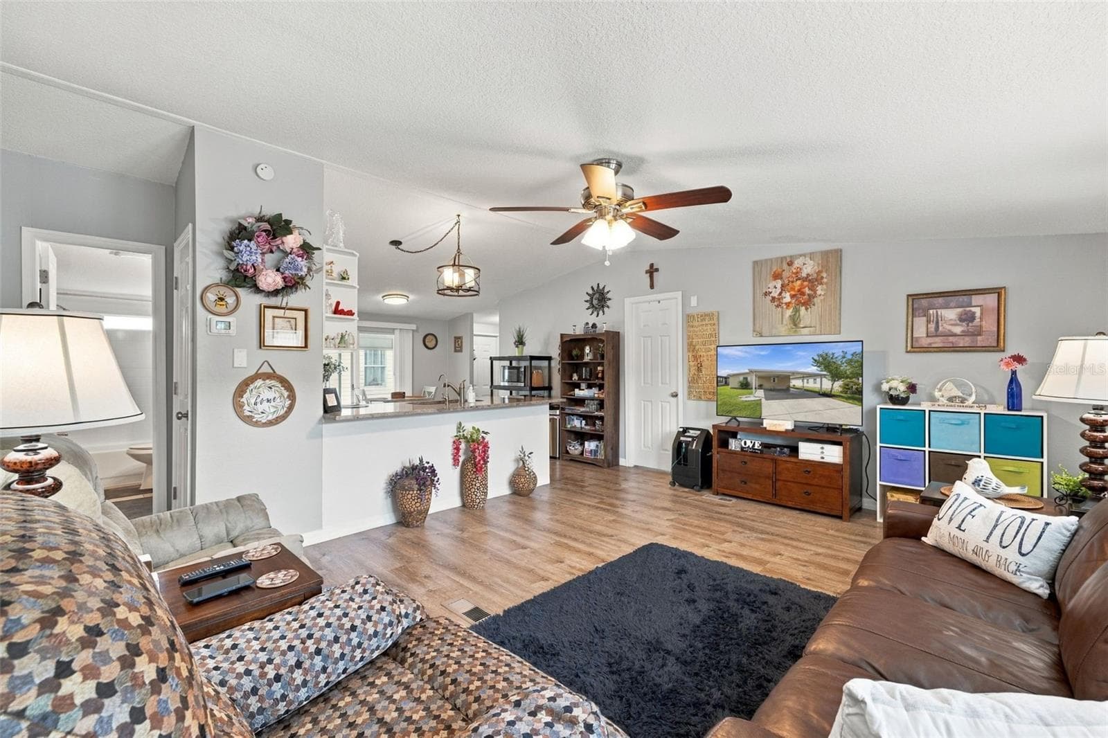Large family room just off the kitchen!  Life Proof Laminate flooring throughout most of the home, including the kitchen, family room and 2 out of 3 bedrooms! Bright open floor plan with updated lighting and fresh paint! - 3041 SHORT LEAF ST, WESLEY CHAPEL