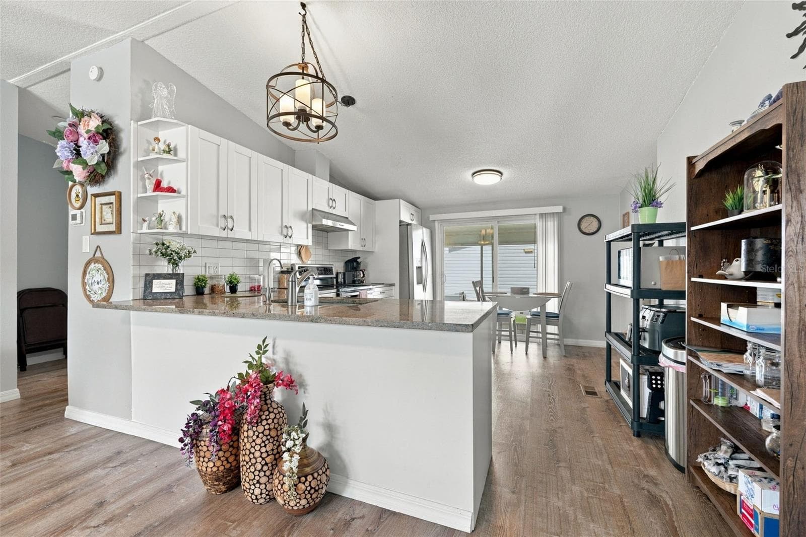 Bright renovated kitchen with shaker style cabinets, soft close drawers, stainless steel appliances, sliding door to the lanai. - 3041 SHORT LEAF ST, WESLEY CHAPEL