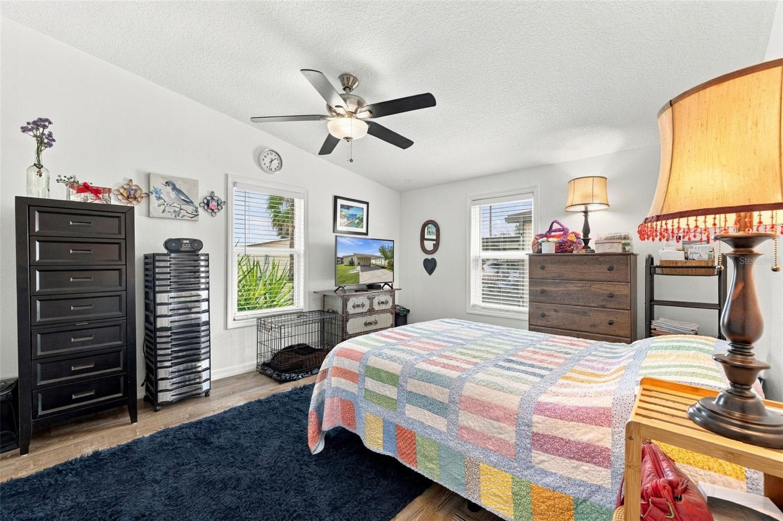 Primary bedroom can easily accommodate a king-sized bed, features laminate flooring, ceiling fan and large walk-in closet. - 3041 SHORT LEAF ST, WESLEY CHAPEL