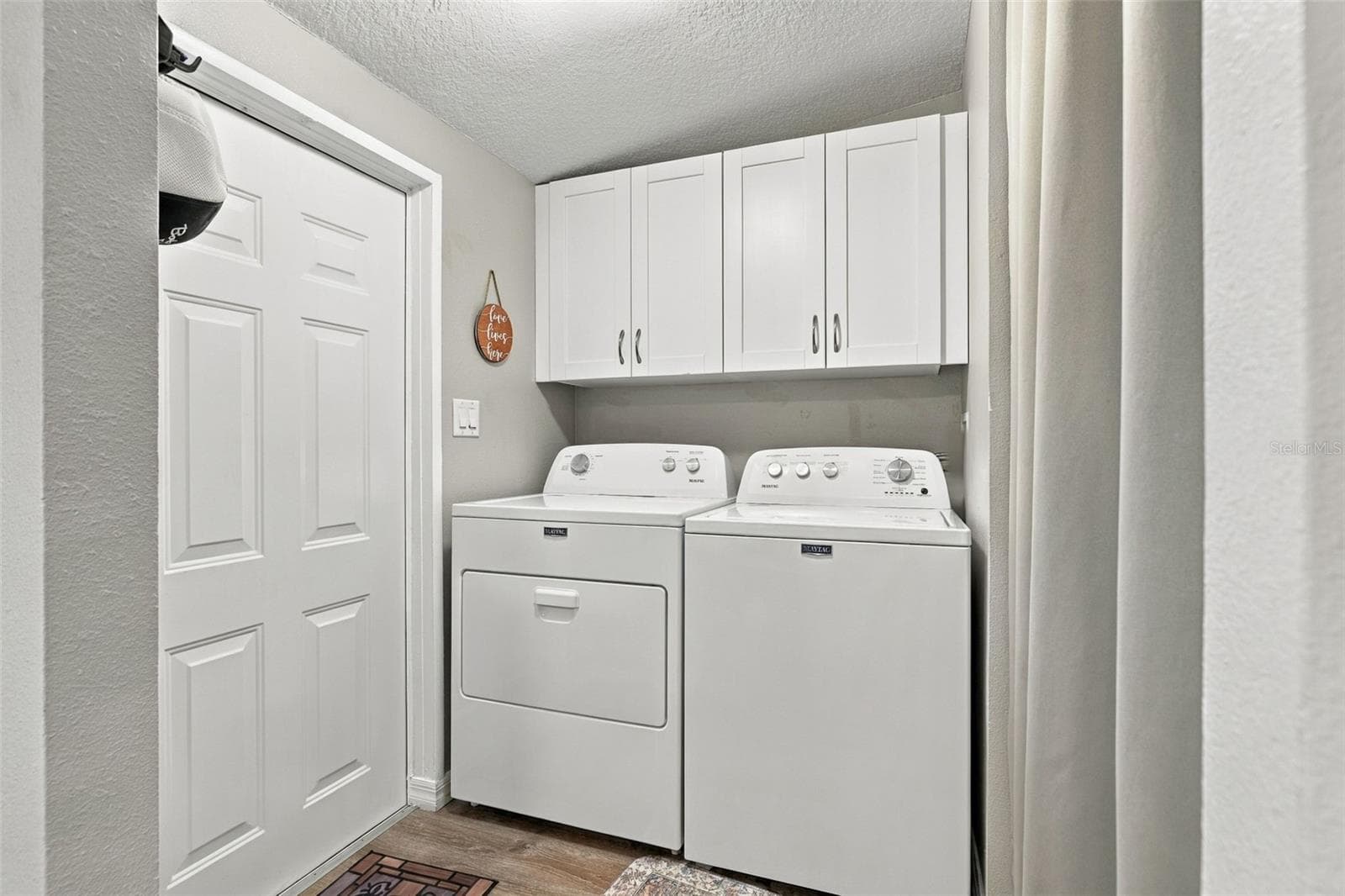 Indoor Laundry with storage, as well as a pantry closet, located right off the kitchen. - 3041 SHORT LEAF ST, WESLEY CHAPEL