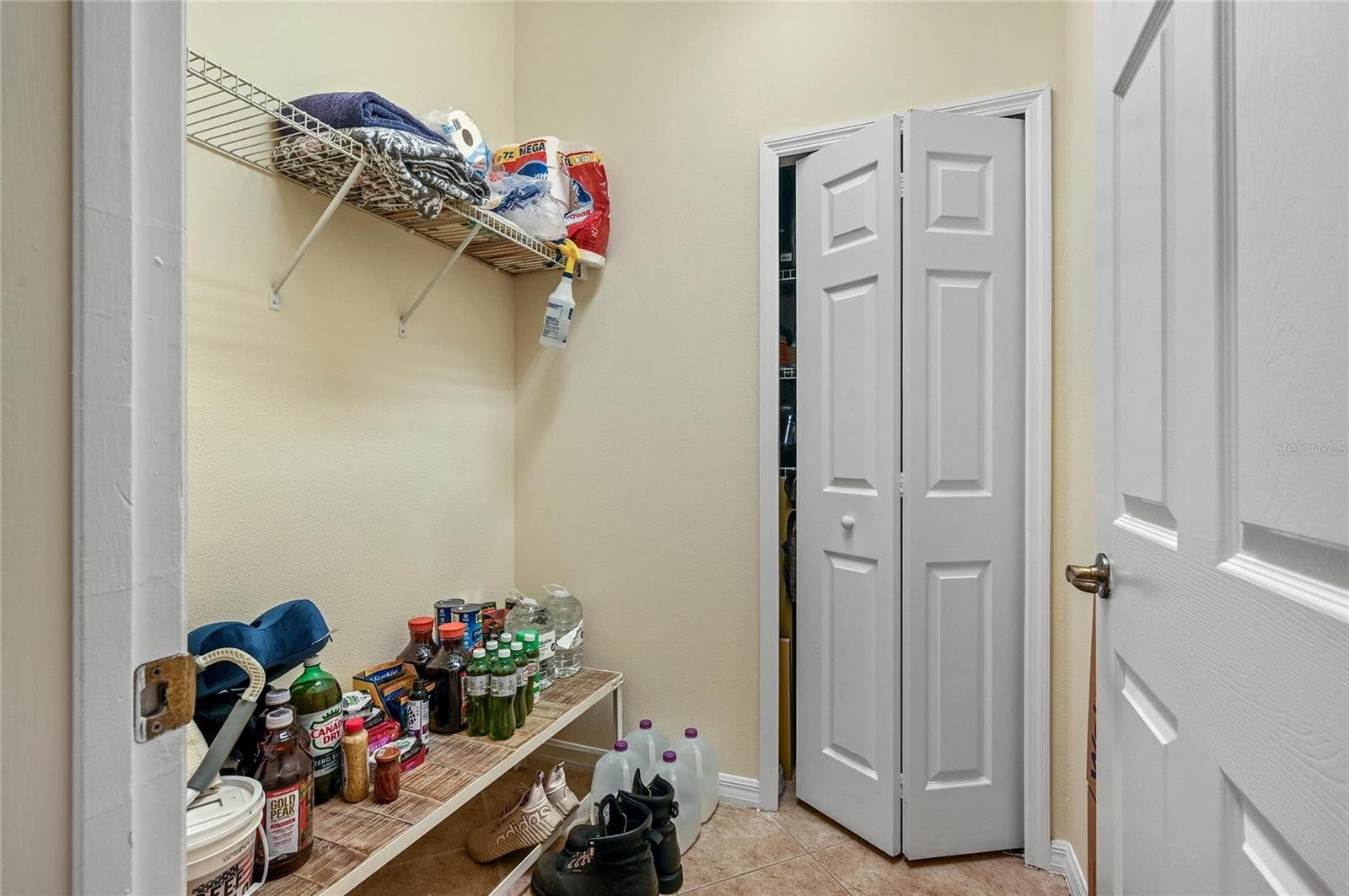 large pantry/storage/mud room off inside off garage entrance door - 104 CANTERBURY BELL DR, OVIEDO
