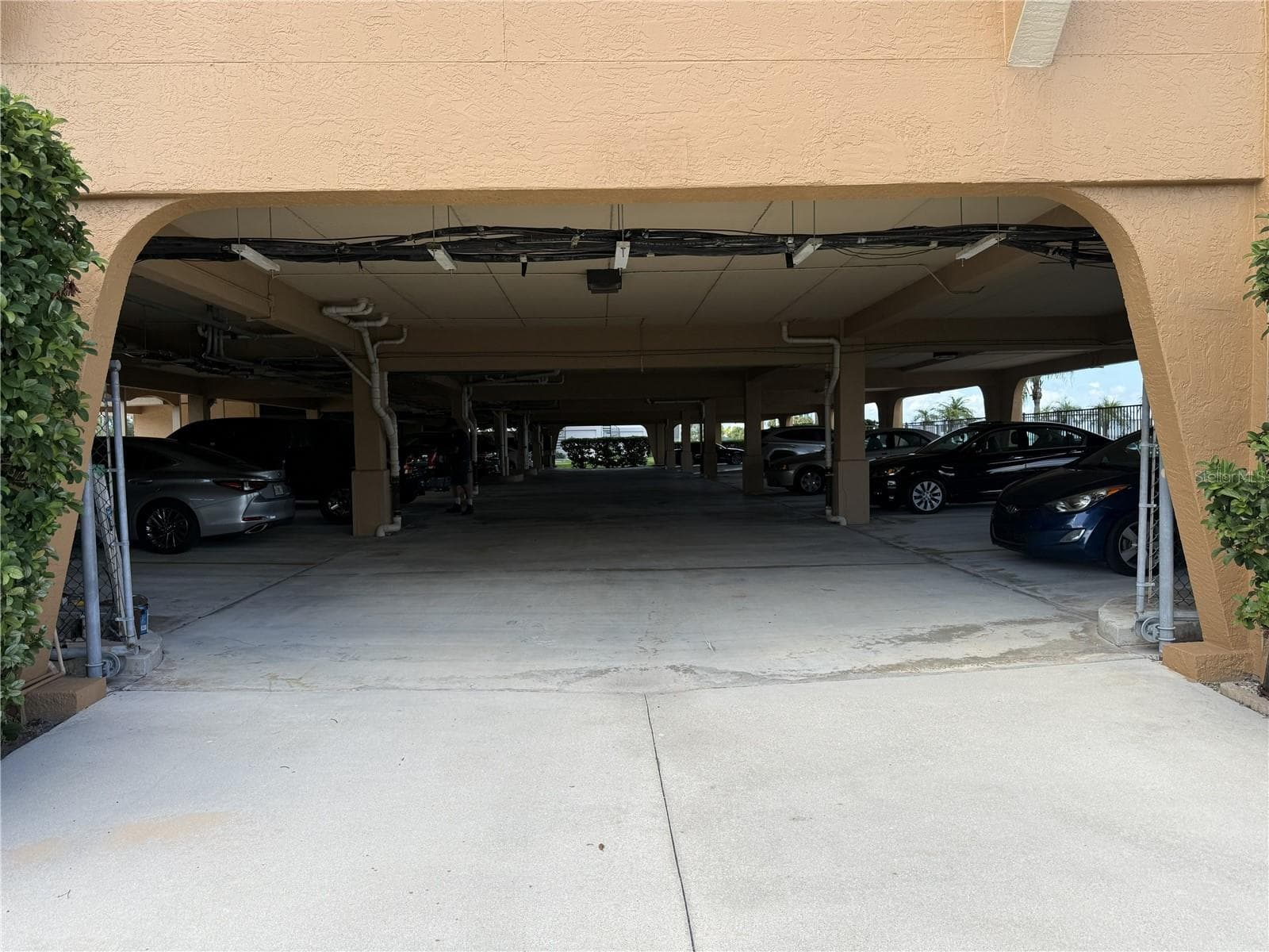 GARAGE ENTRANCE. STORAGE UNIT #18 TO THE IMMEDIATE LEFT. 2 OVERSIZED PARKING SPACES MARKED 18/136 ON THE LEFT SIDE BEFORE THE REMOTE LOBBY DOOR - 1601 PARK BEACH CIR #136/18, PUNTA GORDA