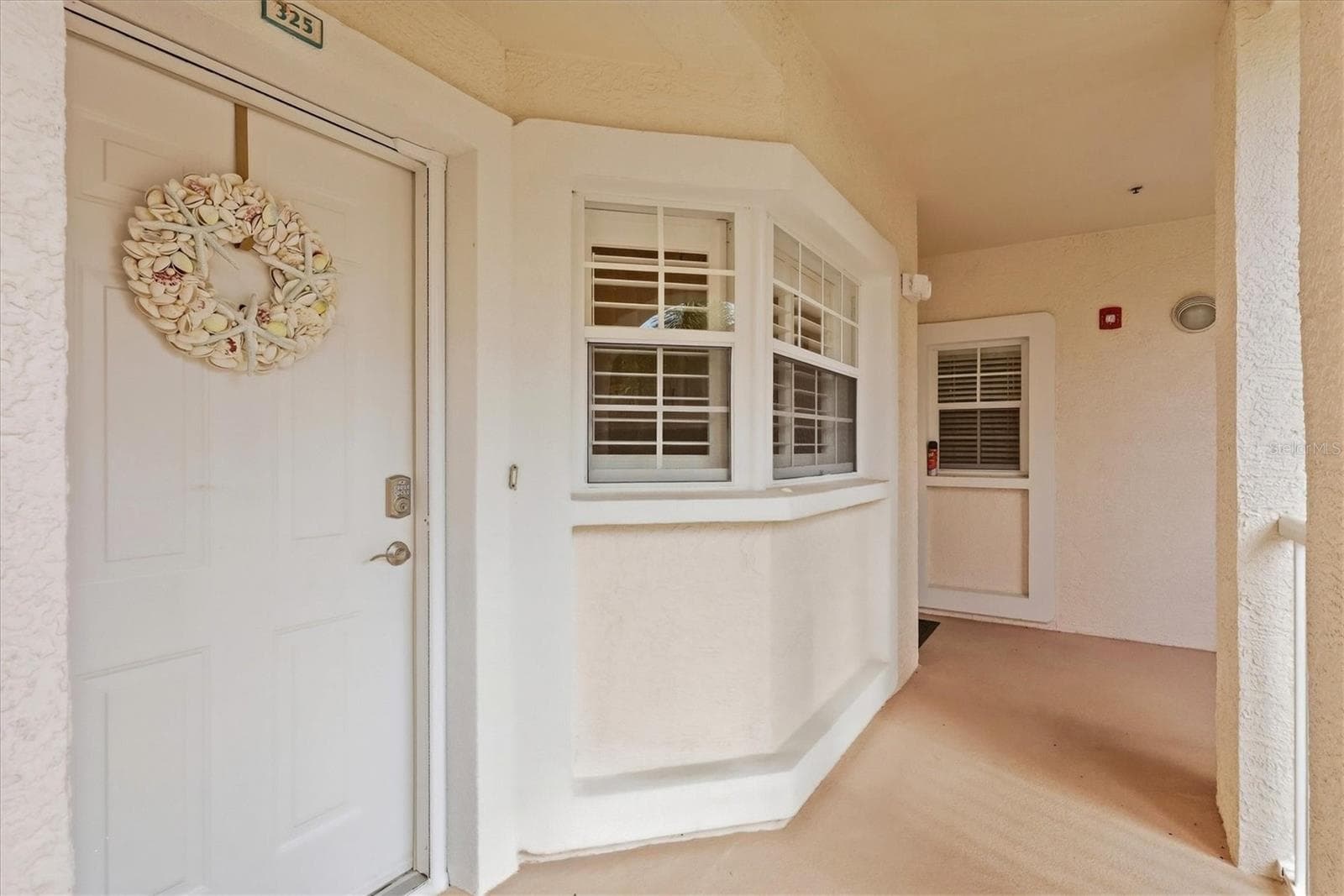 Front door and kitchen windows featuring Plantation Shutters. - 4256 CENTRAL SARASOTA PKWY #325, SARASOTA