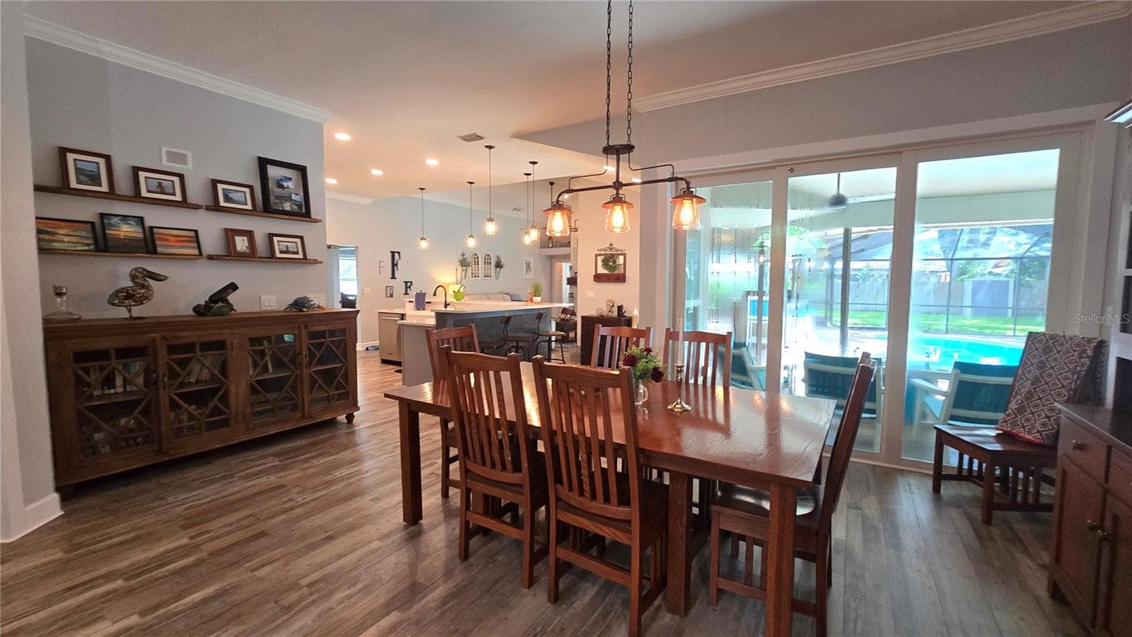 Lovely view from the dining room to the inviting pool area through the sliding glass doors. - 9991 WINDTREE BLVD, SEMINOLE