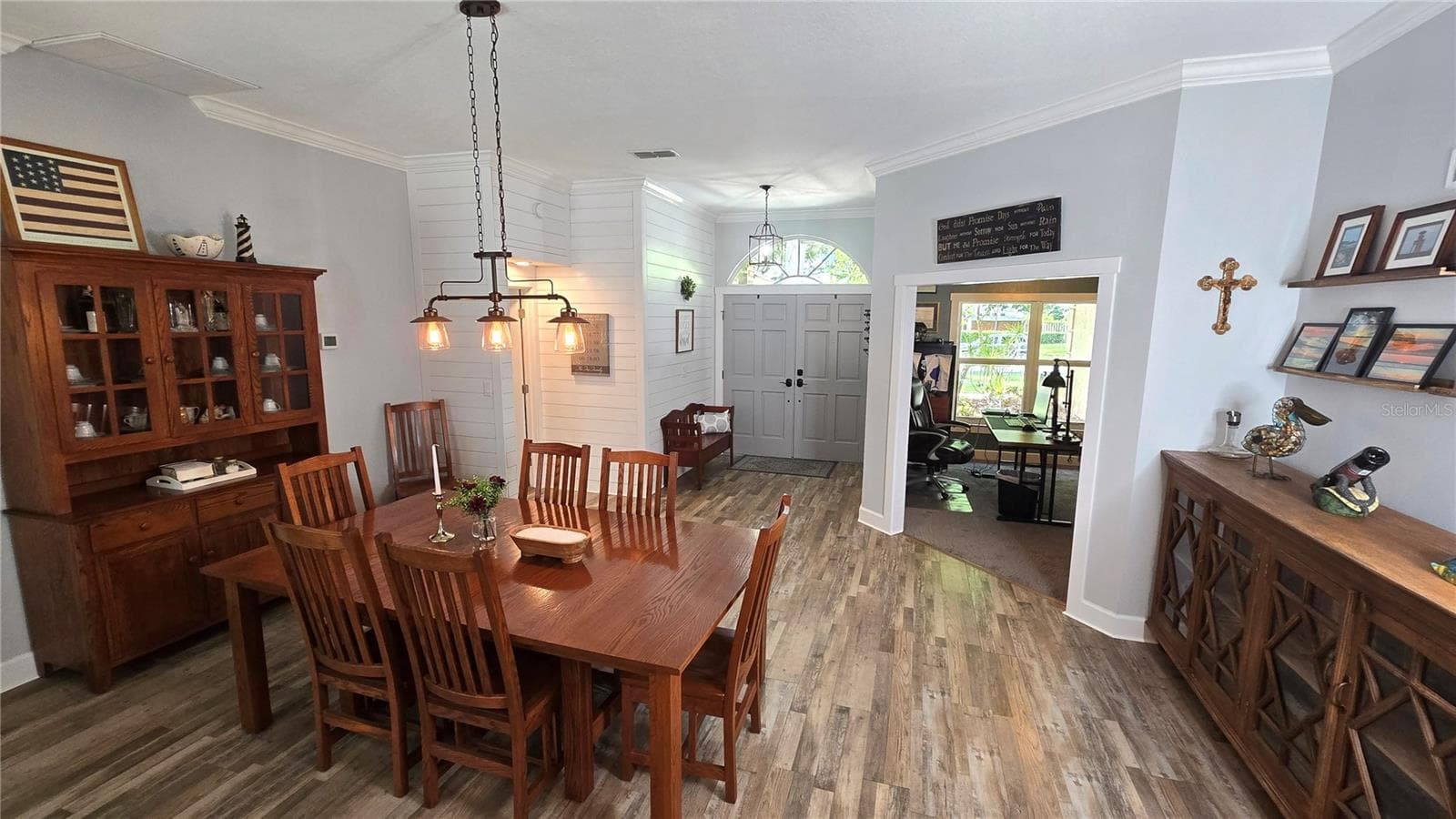 This view is from the back of the dining room facing the front entry door as well as the front office space. - 9991 WINDTREE BLVD, SEMINOLE