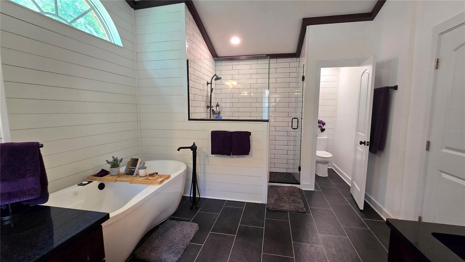 This Primary Bathroom is so large that it not only has a separate tub it also has a huge walk in shower as well as a separate room for privacy while in the bathroom. - 9991 WINDTREE BLVD, SEMINOLE