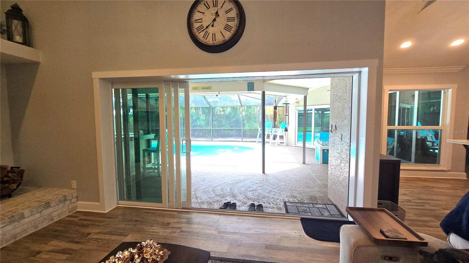 View of the pool area from the family room. - 9991 WINDTREE BLVD, SEMINOLE