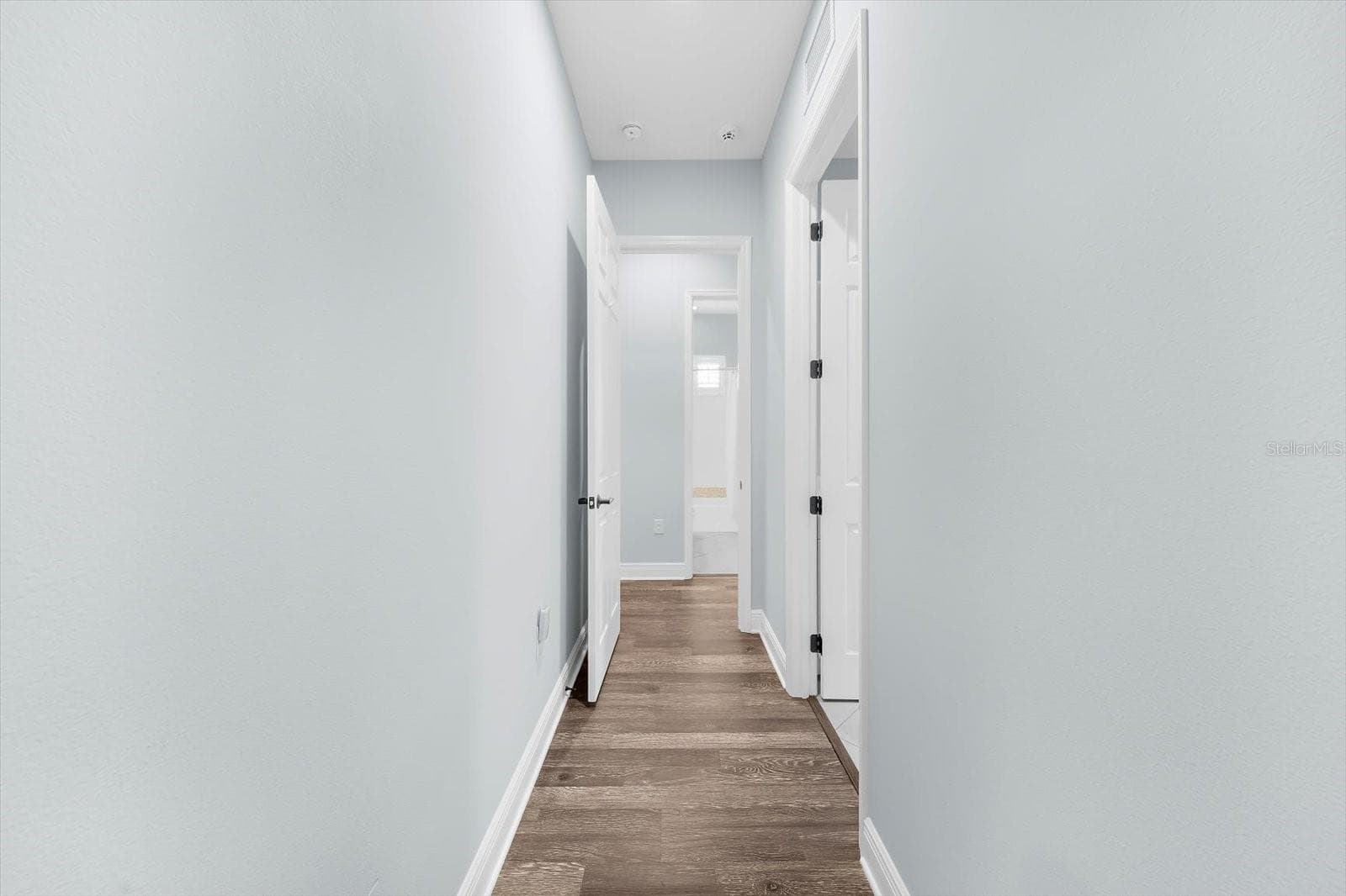 Hallway to Laundry Room, Garage and 2nd & 3rd Bedrooms and 2nd Bath - 8256 LARKSPUR CIR, SARASOTA