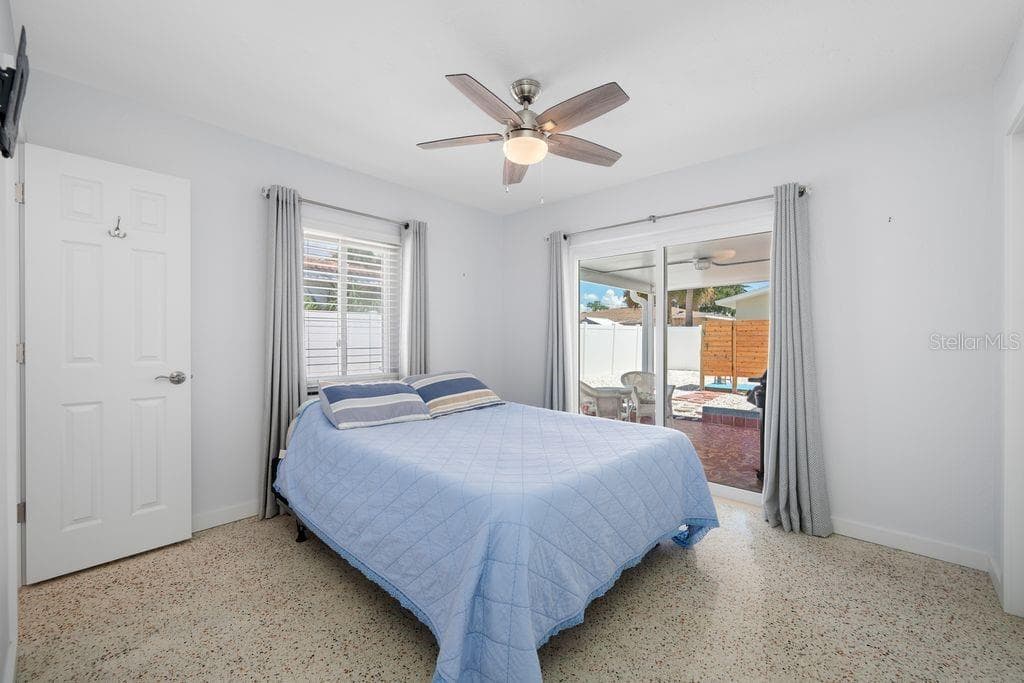 Primary Bedroom with En-Suite Bathroom to the Left and Sliding Glass Door access to Lanai - 1472 DURLING DR S, SOUTH PASADENA