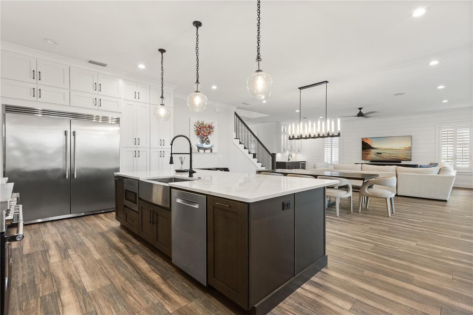 LARGE CENTER ISLANDAn oversized center island with apron-front sink and integrated appliances anchors the kitchen while remaining completely open to the dining and living areas. - 907 CELADON ST, WINTER GARDEN
