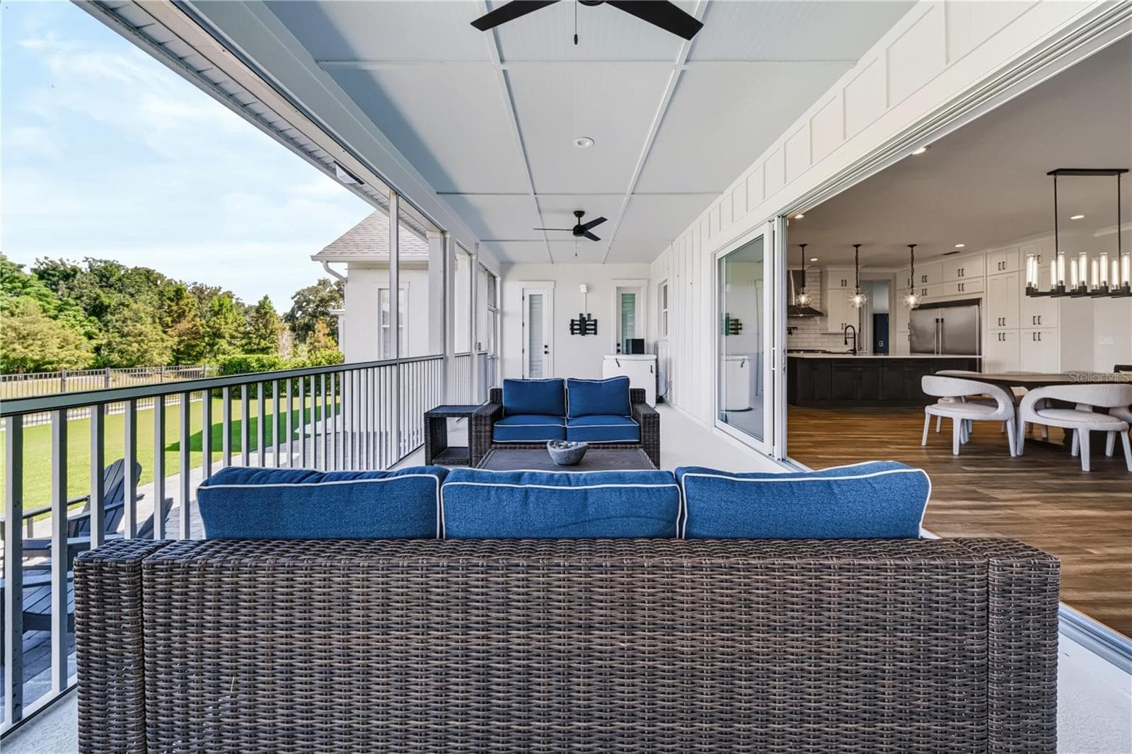 CONSERVATION VIEWSThe screened porch overlooks the backyard and conservation landscape, while wide sliders provide direct access to the kitchen and dining areas. - 907 CELADON ST, WINTER GARDEN
