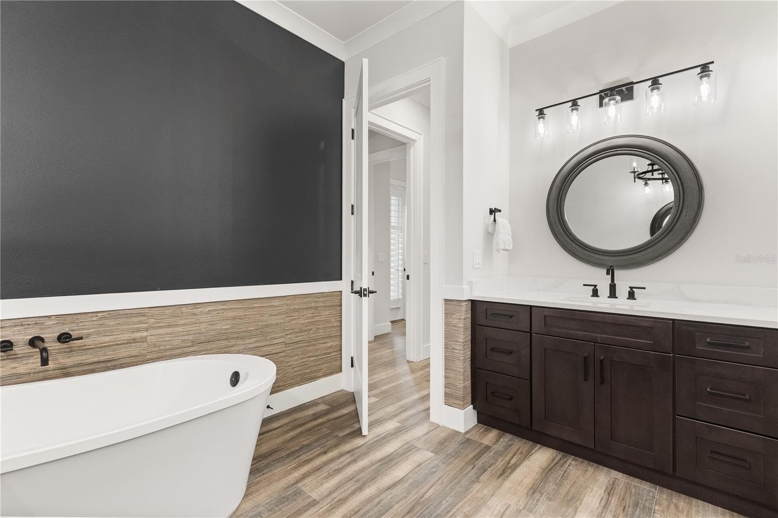 FREESTANDING SOAKING TUBThe primary bath features a freestanding soaking tub, generous vanity storage and a separate walk-in shower. - 907 CELADON ST, WINTER GARDEN
