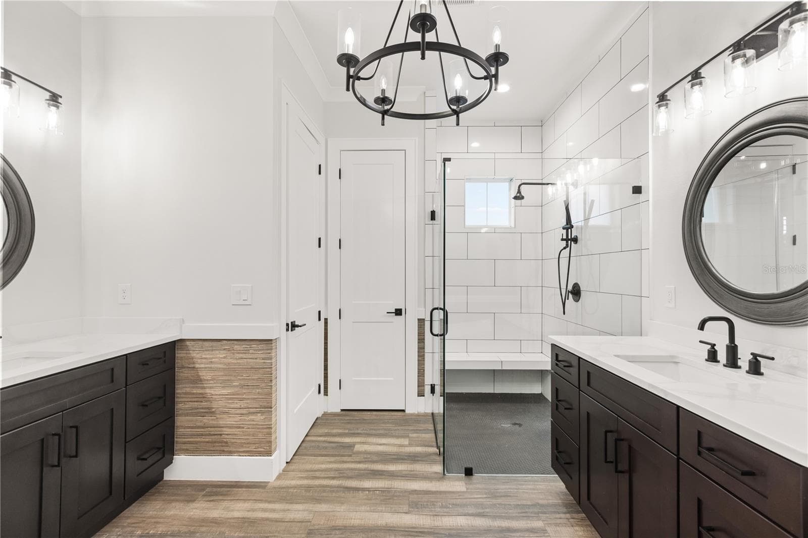 DUAL VANITIES + WALK-IN SHOWERThe primary bath includes separate vanities, a glass-enclosed walk-in shower, private water closet and a dedicated linen closet positioned beside the shower. - 907 CELADON ST, WINTER GARDEN