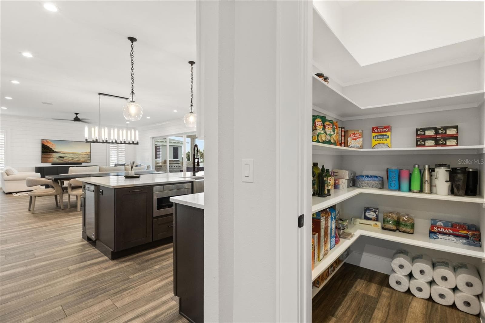 WALK-IN PANTRYA walk-in pantry just off the kitchen provides generous wraparound shelving and sits along the transition to the mudroom and adjacent laundry room. - 907 CELADON ST, WINTER GARDEN