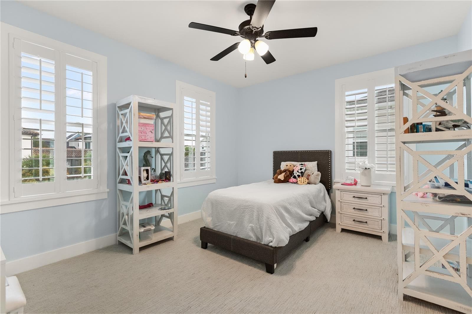 SECOND-FLOOR EN SUITE BEDROOMOne of three upstairs bedrooms, this generously sized room includes its own en suite full bath, abundant natural light and plantation shutters. - 907 CELADON ST, WINTER GARDEN