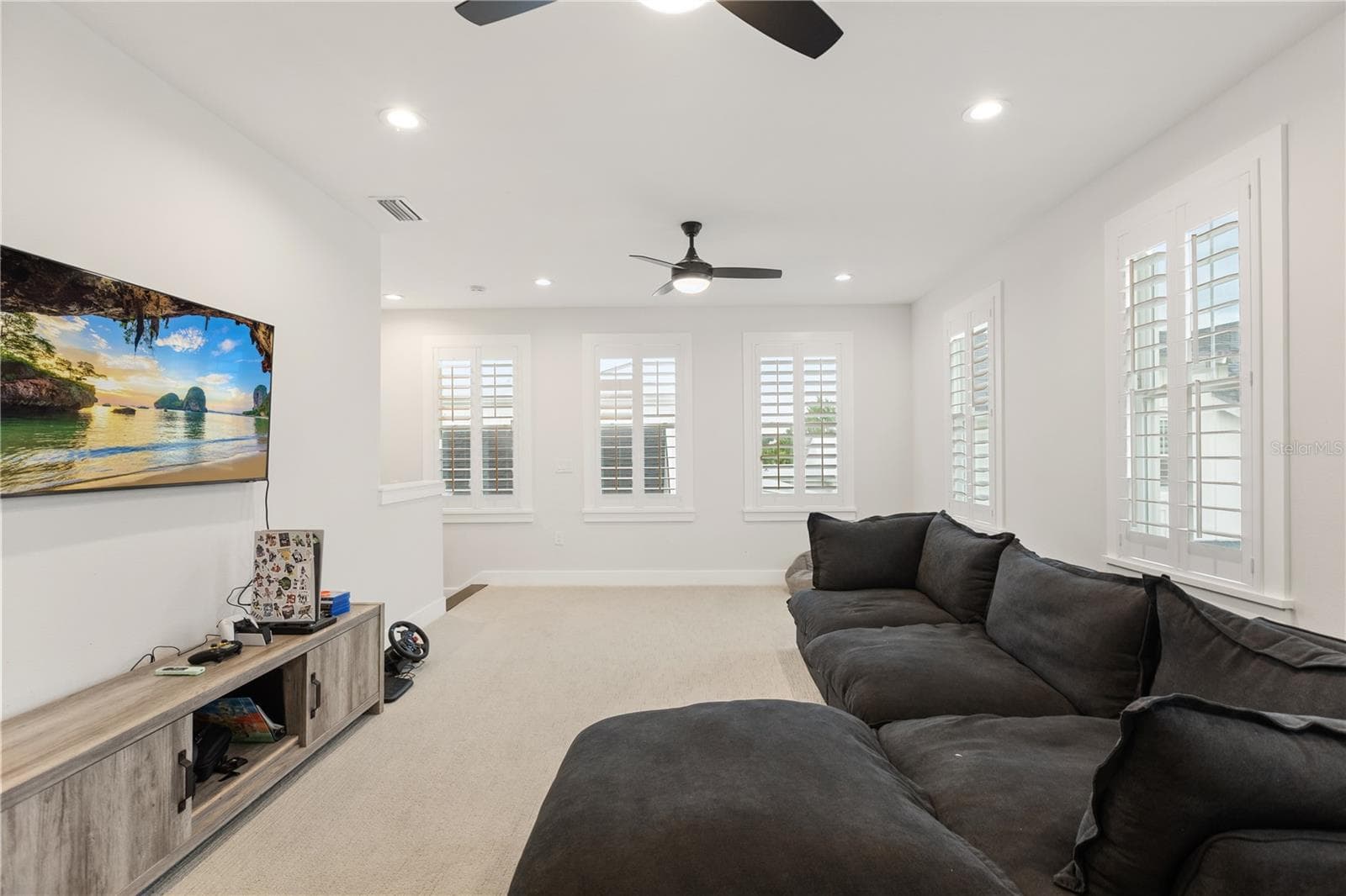 SECOND-FLOOR LOFTThe expansive 25' × 15' second-floor loft creates a separate gathering space for movies, gaming, homework or lounging, apart from the main living areas downstairs. - 907 CELADON ST, WINTER GARDEN