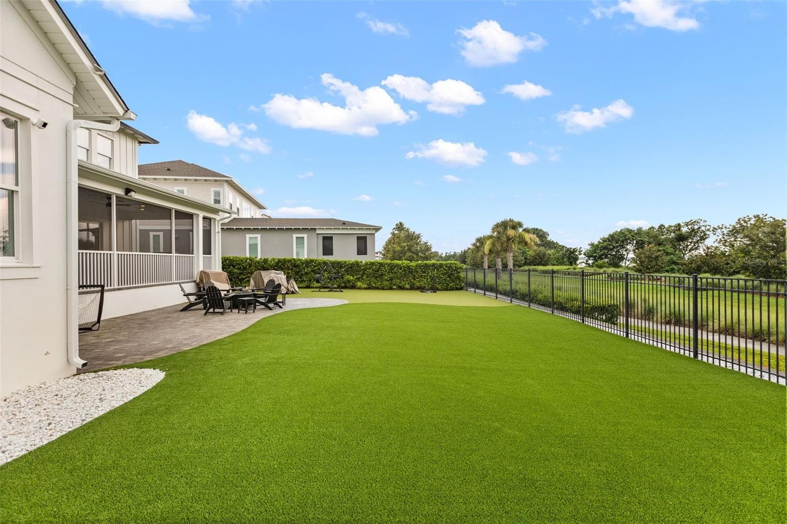 EXPANSIVE FENCED BACKYARDA broad fenced backyard finished with low-maintenance turf provides substantial space for recreation, entertaining and future outdoor improvements, with conservation land beyond. - 907 CELADON ST, WINTER GARDEN