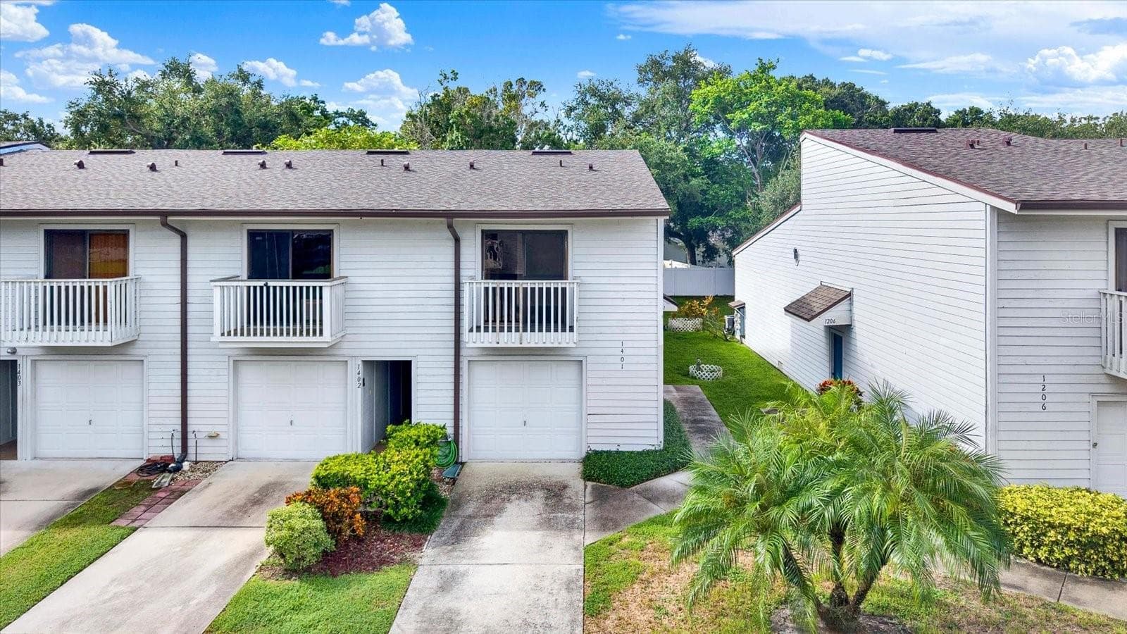 END UNIT FRONT EXTERIOR WITH EXTRA WIDE SINGLE CAR GARAGE AND SIDE ENTRY FRONT DOOR - 6410 92ND PL N #1401, PINELLAS PARK