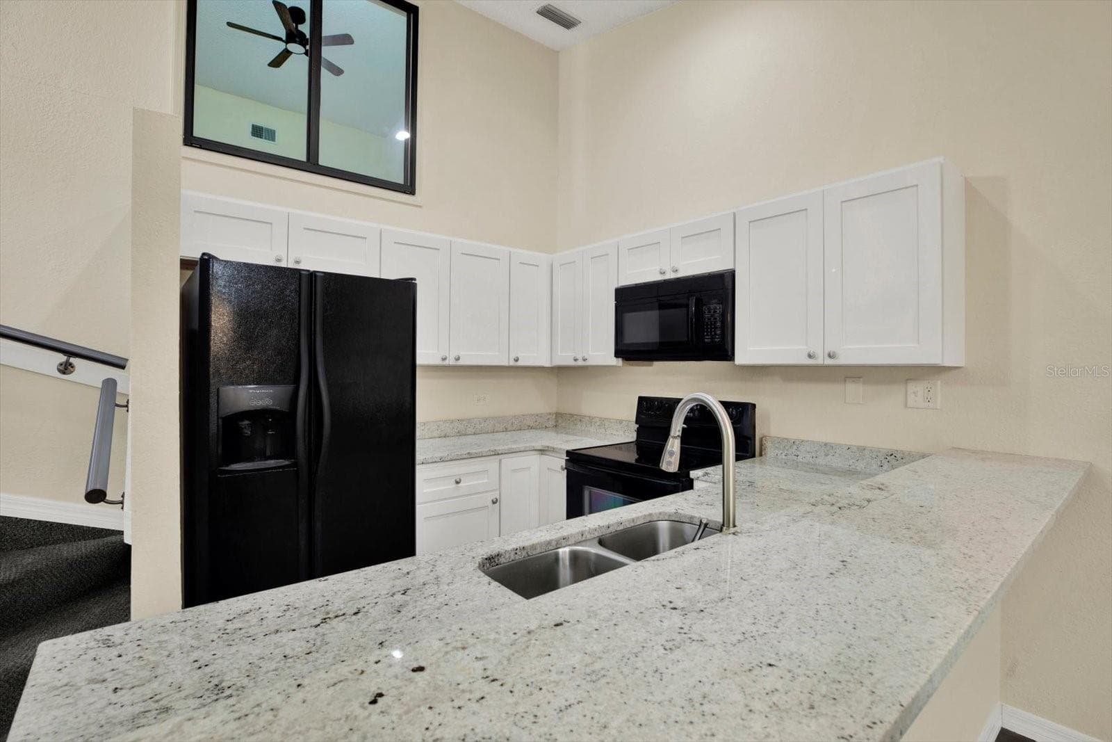 KITCHEN WITH BEAUTIFUL GRANITE COUNTERTOPS UPDATED CABINETRY WITH SOFT CLOSE DOORS - 6410 92ND PL N #1401, PINELLAS PARK