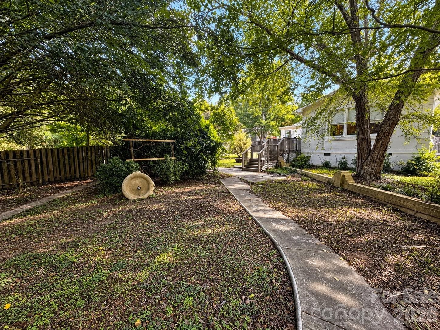 Shaded Backyard Path to Deck - 4711 Summit Avenue, Greensboro