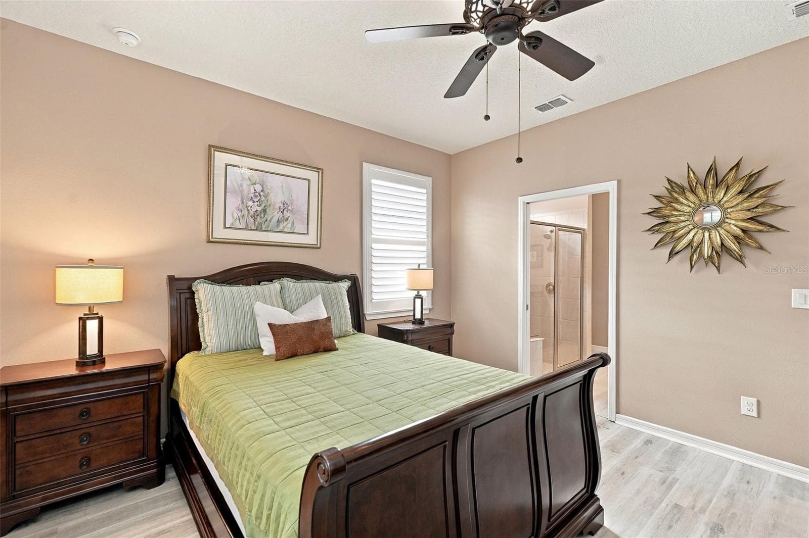 Primary Bdrm w/luxury vinyl plank floors, ceiling fan, & windows w/plantation shutters - 5995 SW 93RD CIR, OCALA