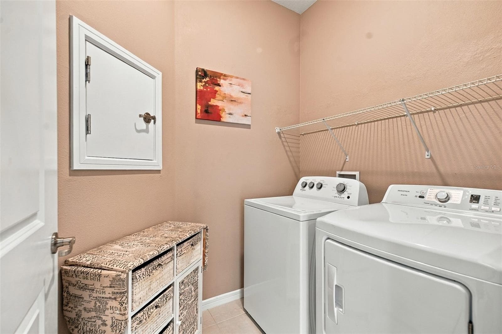 Indoor Laundry Room w/washer & dryer set, built-in shelf, & laundry chute door to Primary Closet - 5995 SW 93RD CIR, OCALA