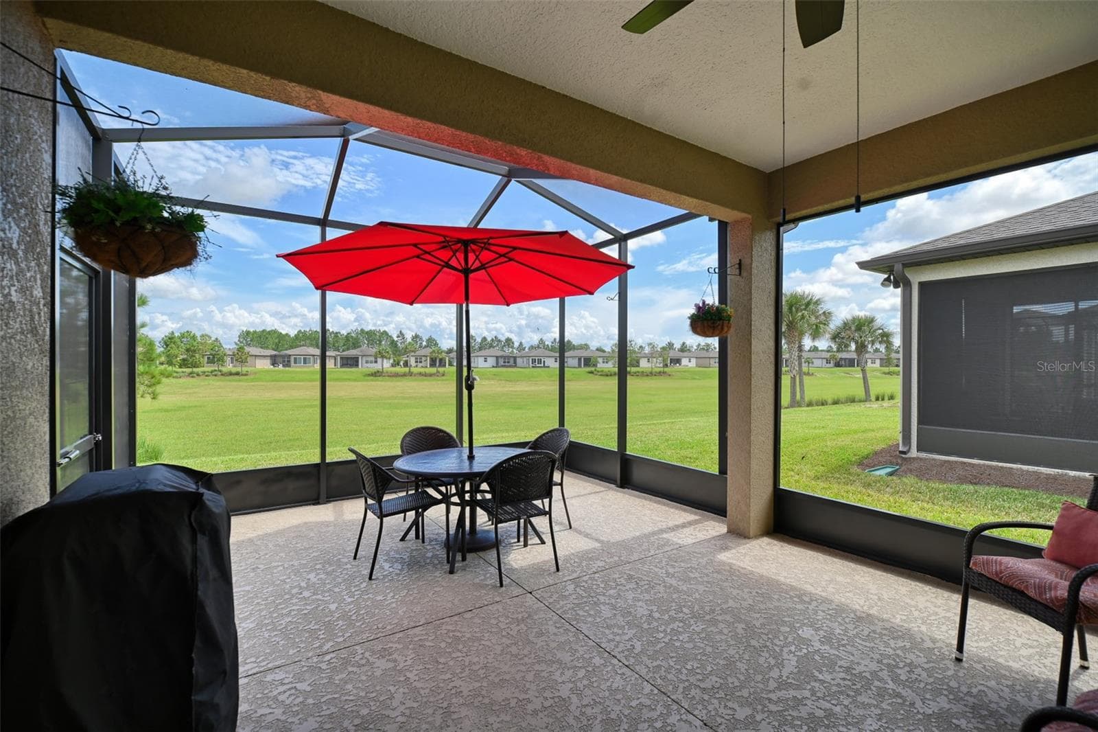 Covered, screened lanai w/additional screen cage overlooking greenbelt dry retention area - 5995 SW 93RD CIR, OCALA